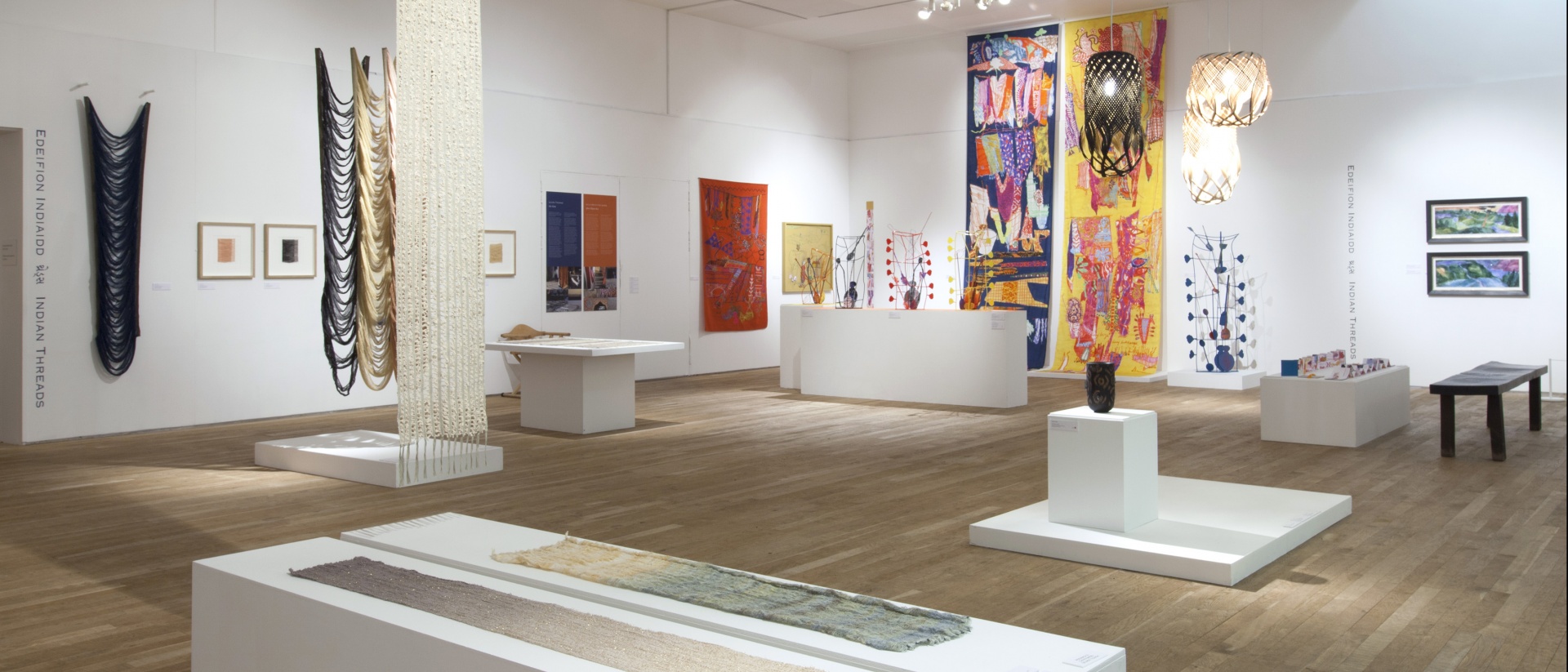 Exhibition of colourful textiles within a white space