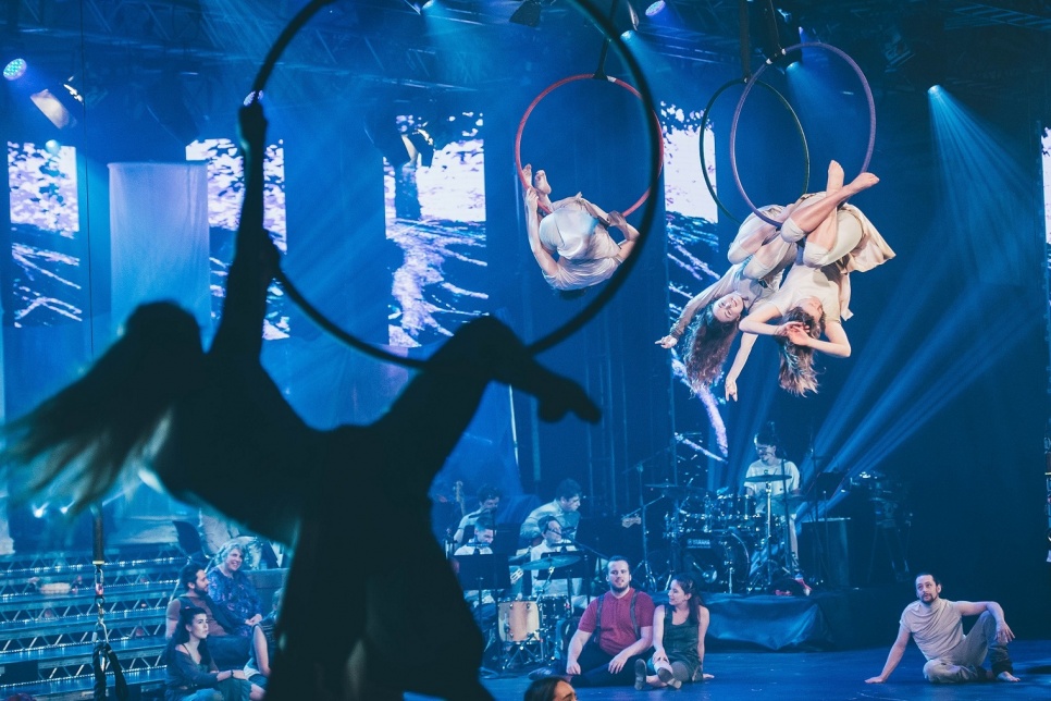 Circus performance with suspended hoops and acrobats 