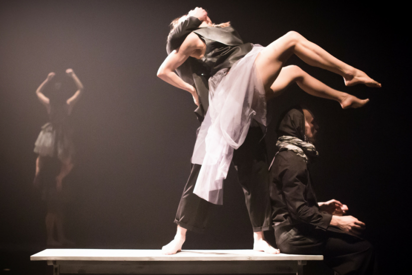 dancing couple under a spotlight on stage