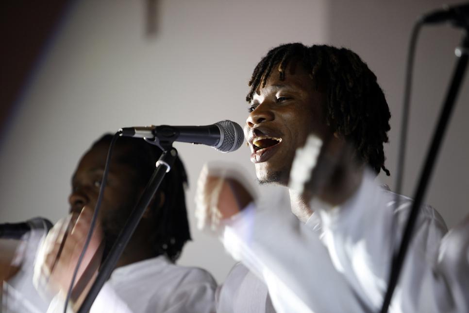 A man sings into a microphone 