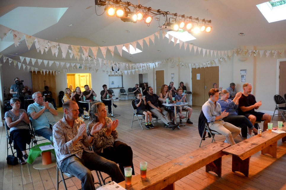 An audience in Rudry clapping in  a concert