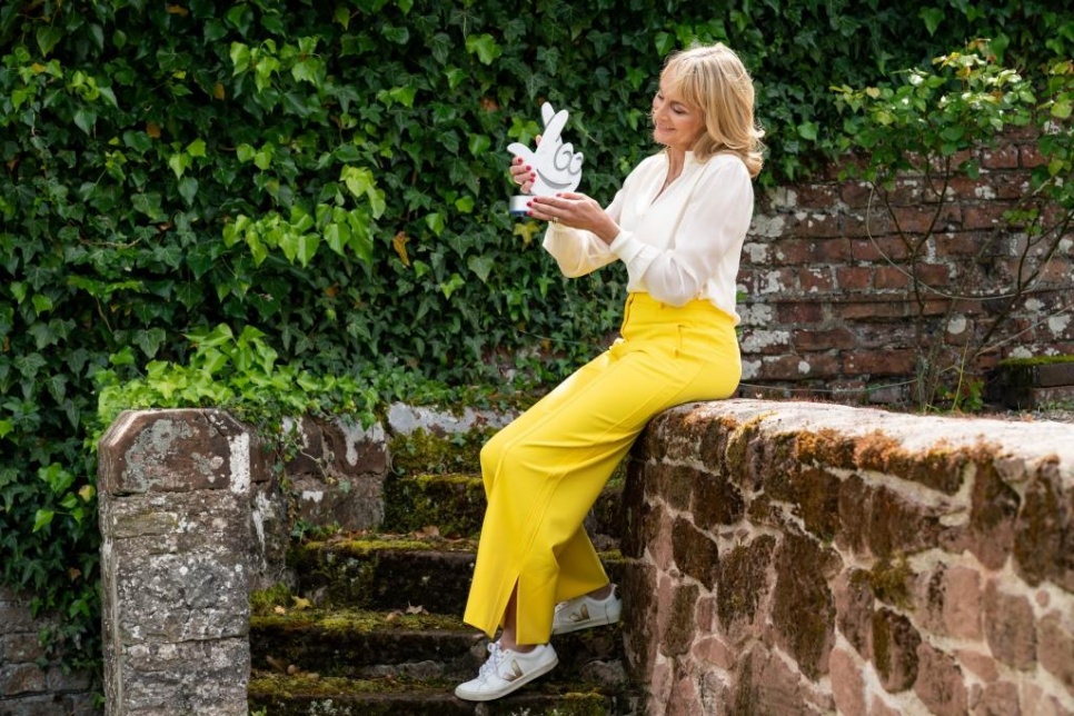 Louise Minchin holding National Lottery logo