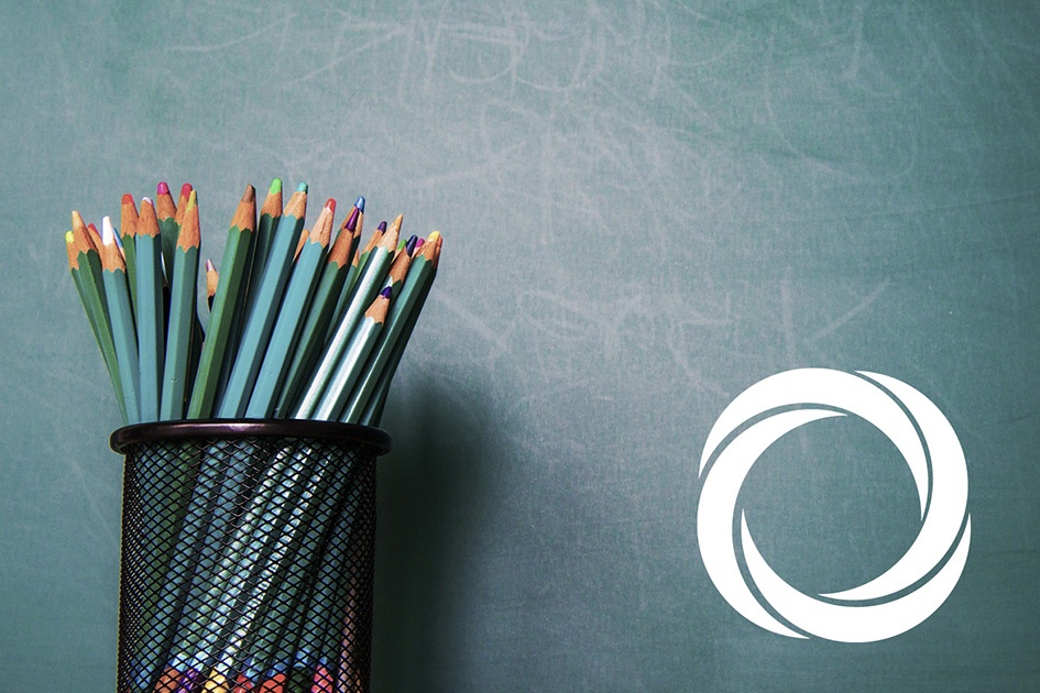 A pot of pencils next the Art Council's logo