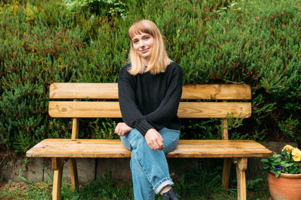 Image of Georgia Ruth sat on a bench. Image by Rhodri Brooks